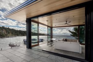 Lift and Slide Glass Walls Open Interior to Outdoor Patio Cottage Design